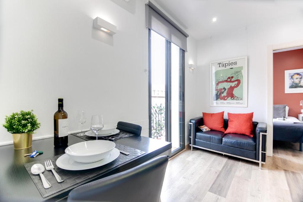 a living room with a dining table and a couch at Nicebarcelonaapartments in Barcelona