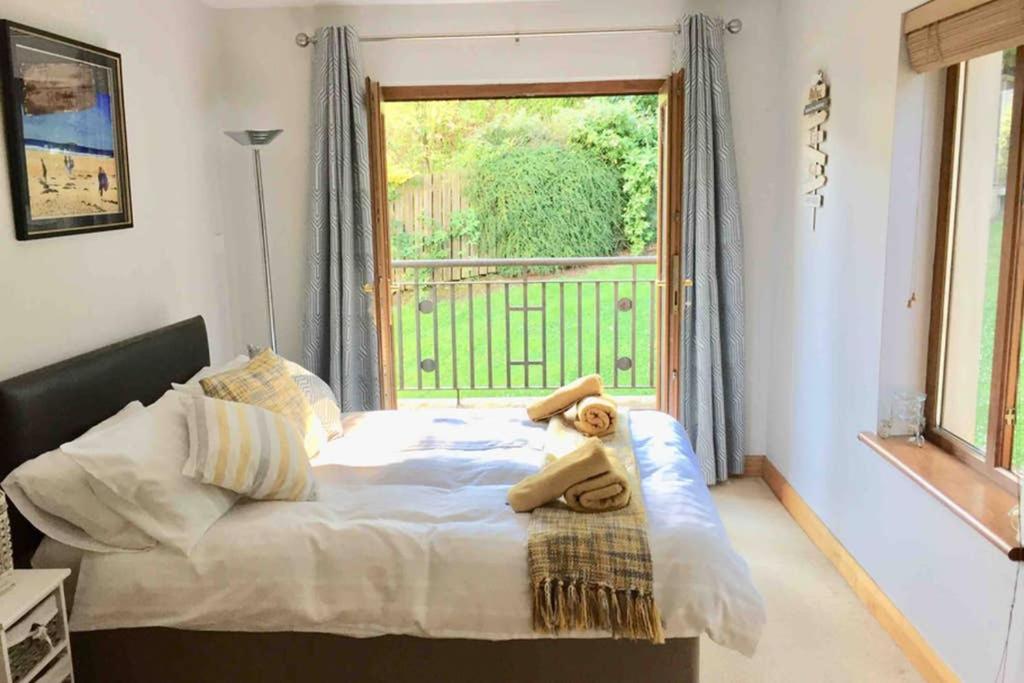 a bedroom with a bed with a teddy bear on it at Parkwood House in Dungannon