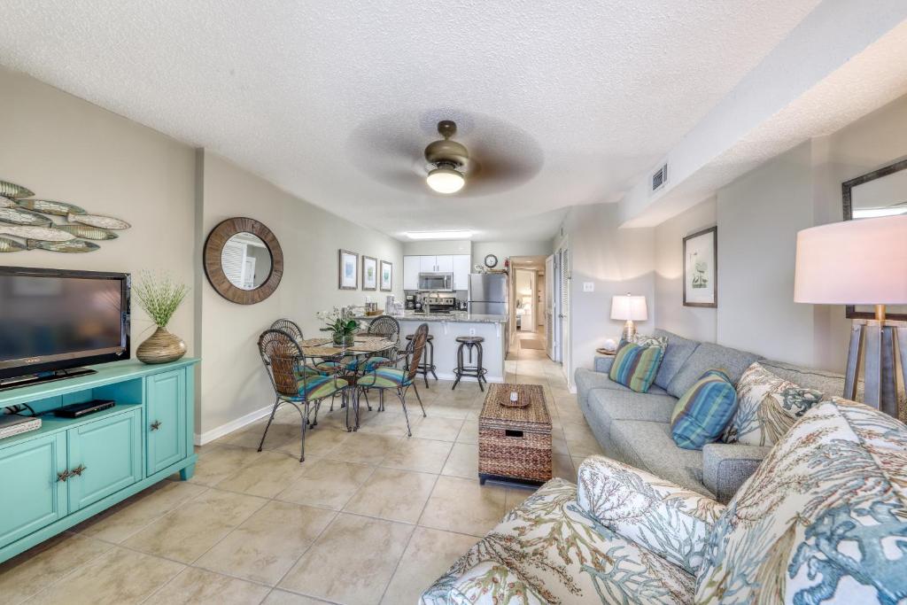 a living room with a couch and a tv at Royal Palms #1006 in Gulf Shores