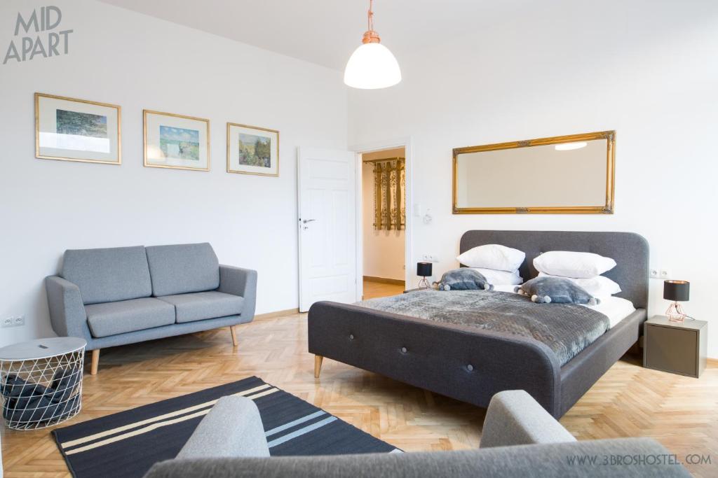 a bedroom with a large bed and a couch at Mid Apart Mennicza Cieszyn in Cieszyn