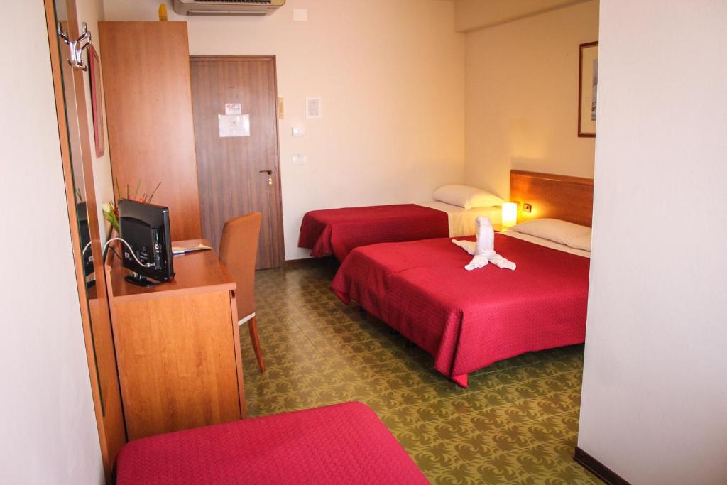 Postel nebo postele na pokoji v ubytování Hotel Centrale