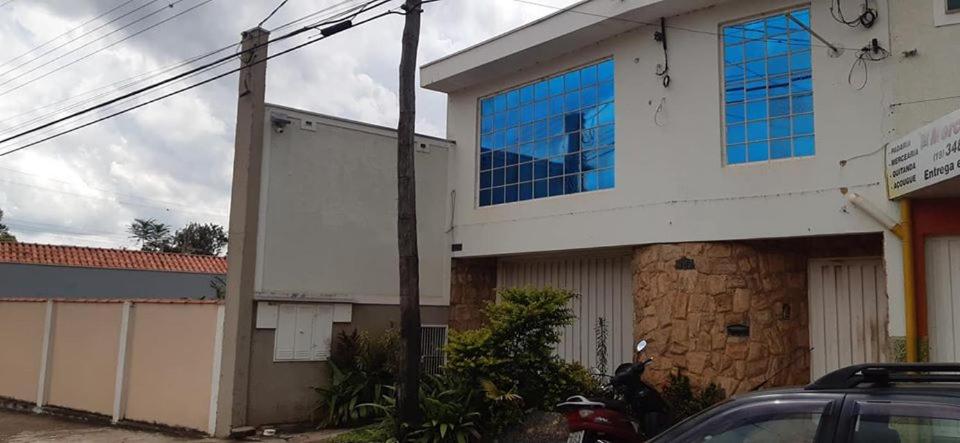 a building with blue windows on the side of it at Apartamento São Pedro SP in São Pedro