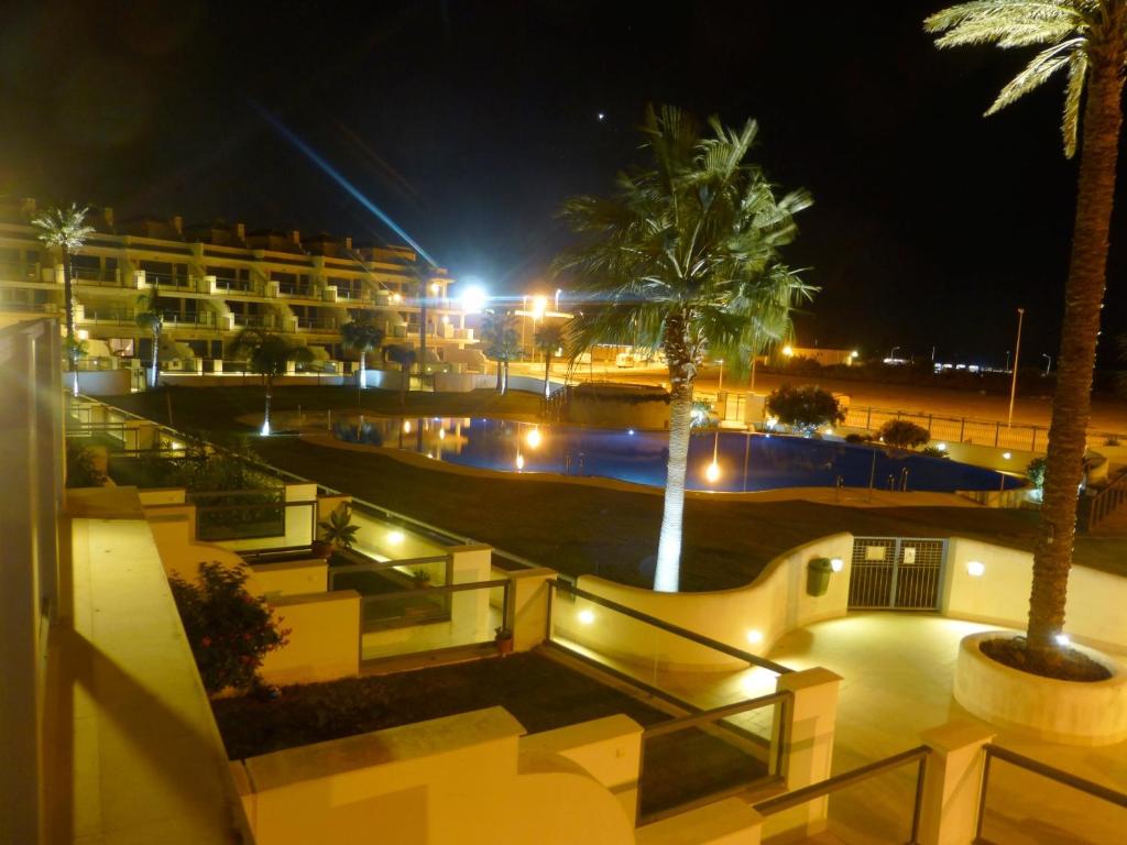 a view of a hotel at night with palm trees at Casa Valdevaqueros in Tarifa