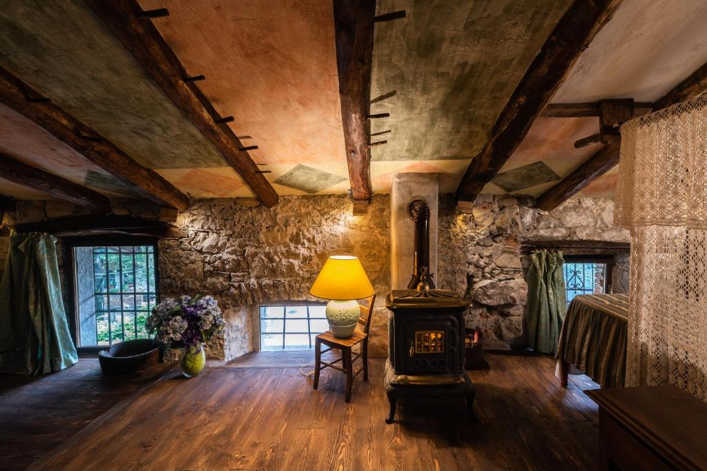 a living room with a wood stove in a room at TORRE DEL GRIFONE nel medioevo di Cividale del Friuli in Faedis