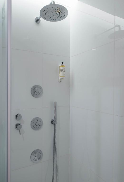 a shower with a glass door in a bathroom at Aroeira Lisbon Hotel - Sea & Golf in Aroeira