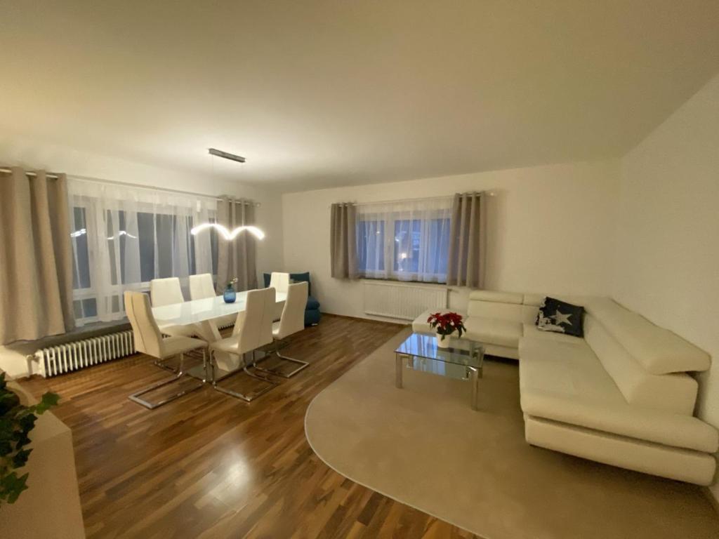 a living room with a white couch and a table at Apartment Bischofshofen in Bischofshofen