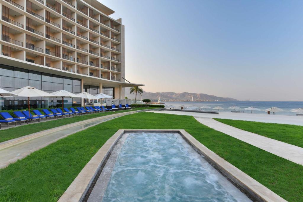 a large pool of water in front of a beach at Kempinski Hotel Aqaba in Aqaba