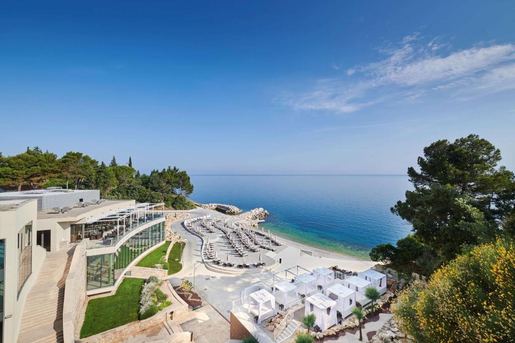 a beach area with a large building and trees at Kempinski Hotel Adriatic Istria Croatia in Savudrija