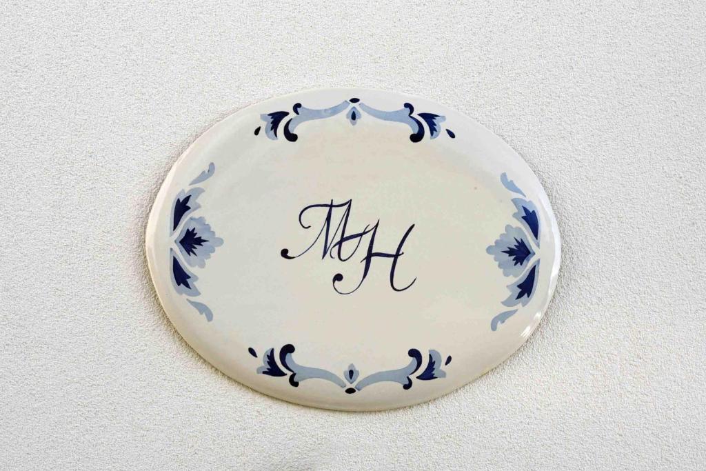 a blue and white plate hanging on a wall at Matteo's House B&b in Amalfi