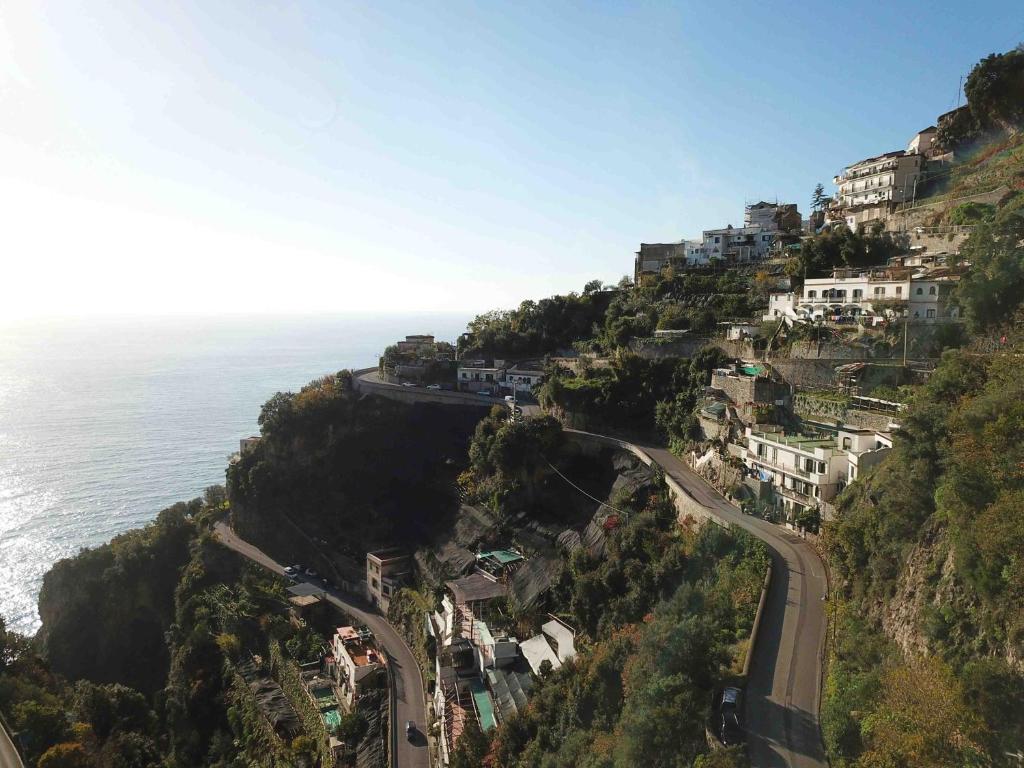 a winding road on a hill next to the ocean at Matteo's House B&b in Amalfi