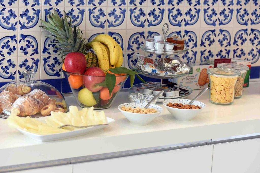a counter with bowls of fruit and other food at Matteo's House B&b in Amalfi