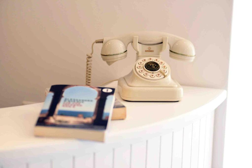 a white phone sitting on top of a white table at Matteo's House B&b in Amalfi