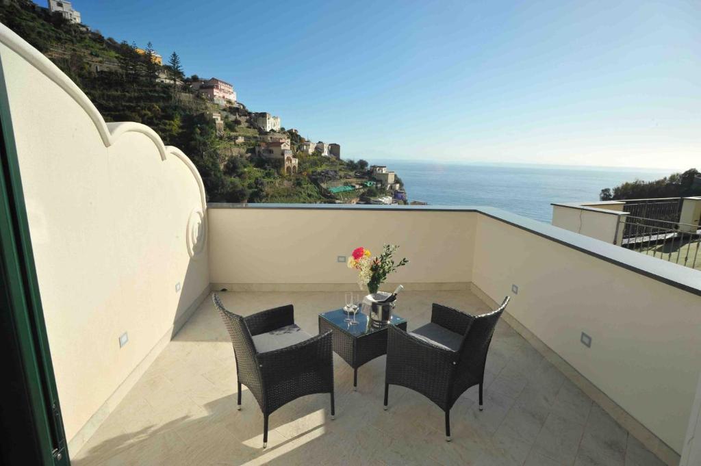 a balcony with a table and chairs and the ocean at Matteo's House B&b in Amalfi