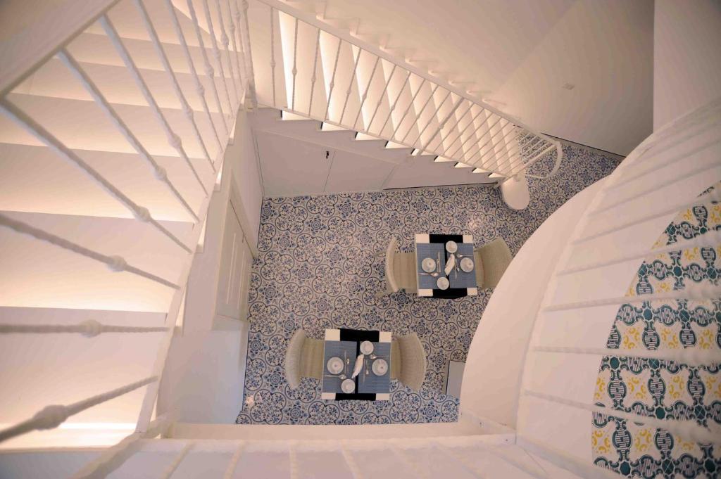 a staircase in a house with white and blue tiles at Matteo's House B&b in Amalfi
