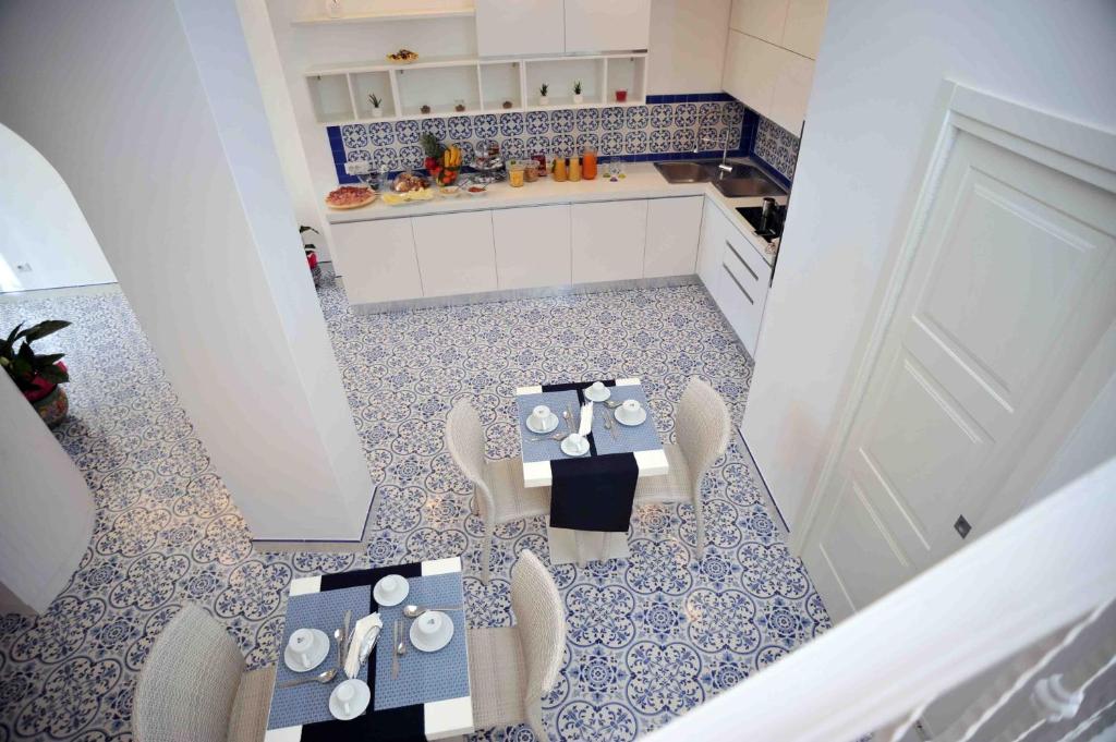a kitchen with a table and chairs and a white door at Matteo's House B&b in Amalfi