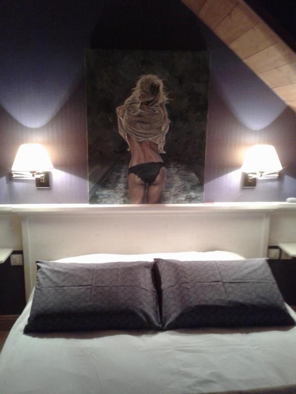 a bedroom with a picture of a woman in the bath room at Gite Habsiger in Ottrott