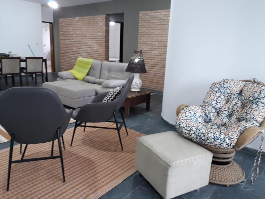 a living room with a couch and chairs at APARTAMENTO PRAIA CENTRO in Ubatuba