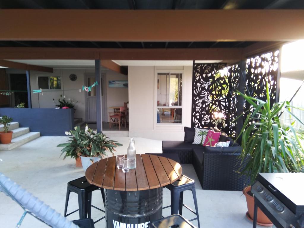 a patio with a table and a couch at Cosy, self-contained and central to everywhere in Gold Coast