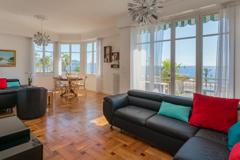 a living room with a black couch and a table at Le Panoramic, fantastic view! in Nice