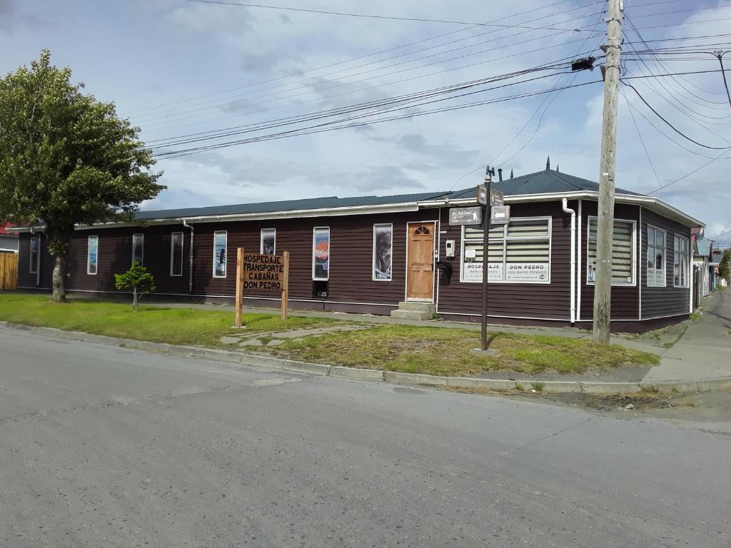 a building on the corner of a street at Hostal Don Pedro in Puerto Natales