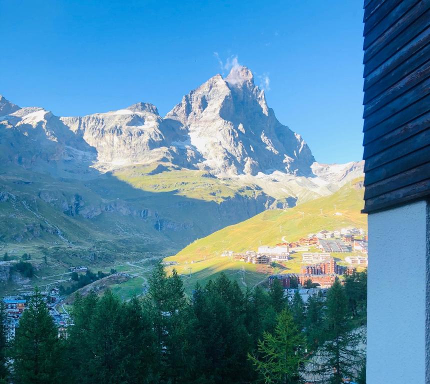 a view of a mountain with a town and a city at Panoramic Apartment in Breuil-Cervinia