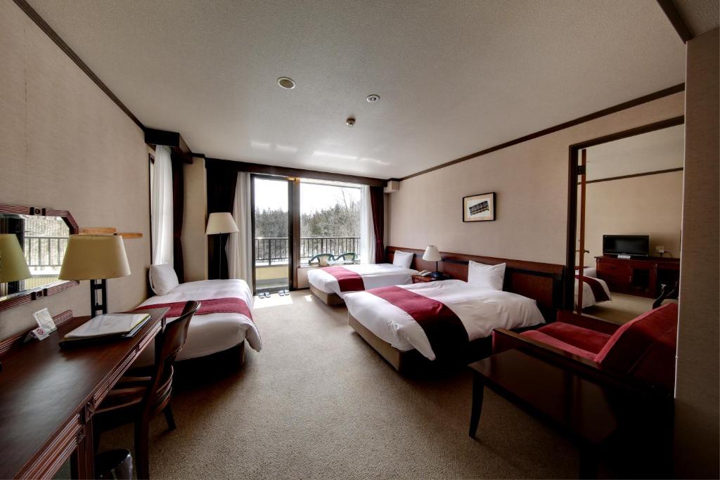 Postel nebo postele na pokoji v ubytování Hakuba Mominoki Hotel