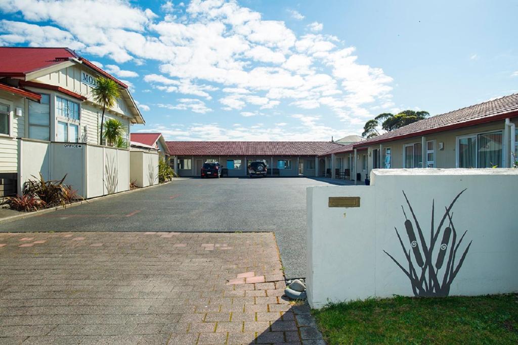 an empty parking lot in front of some buildings at AhiKaa Gisborne Motel in Gisborne