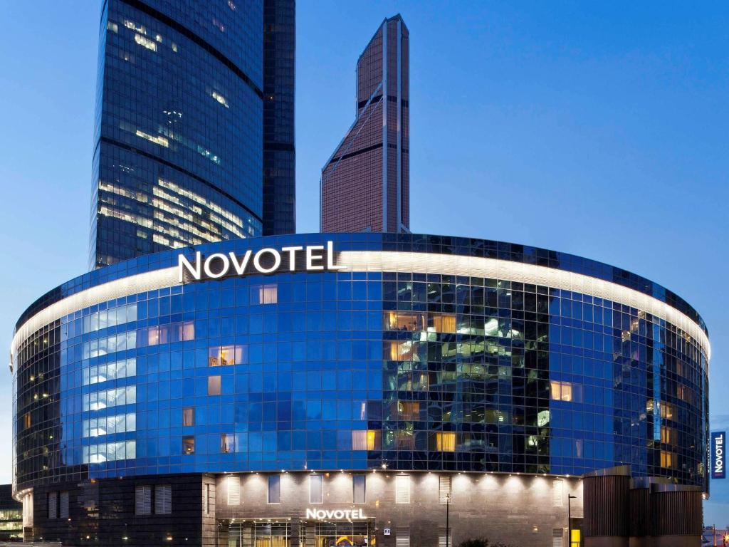 a large building with a clock on the side of it at Novotel Moscow City in Moscow