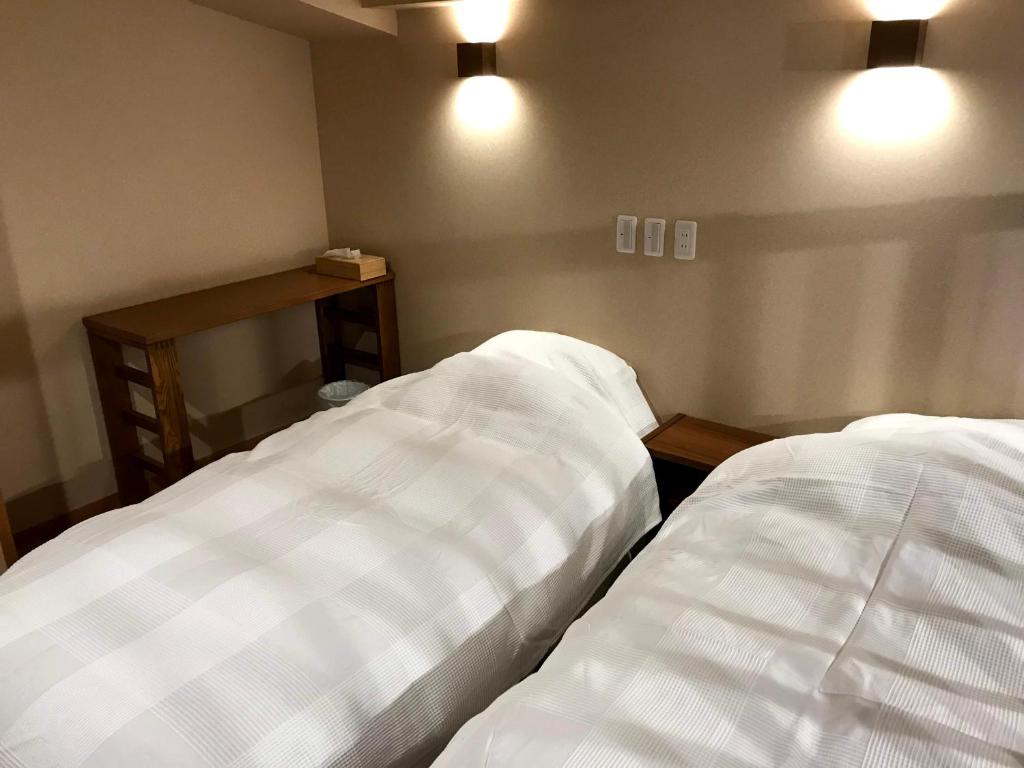 Postel nebo postele na pokoji v ubytování Nozawa Onsen Utopia