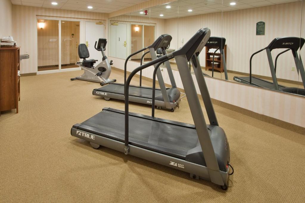 a gym with three tread machines in a room at Holiday Inn Express Hotel & Suites Drums-Hazelton, an IHG Hotel in Drums