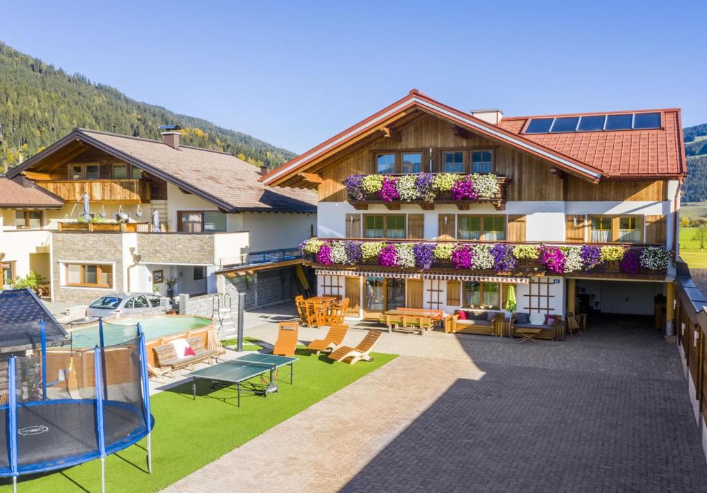 a large house with a yard with a gazebo at Appartement Oberreiter in Flachau