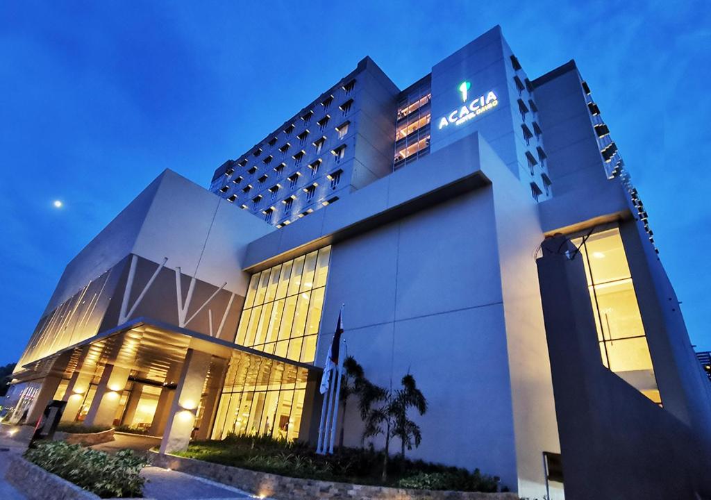 a hotel building with a sign on the front of it at Acacia Hotel Davao in Davao City