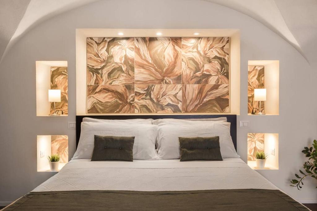a bedroom with a large painting above a bed at Le Pennellate Short Lets in Catania