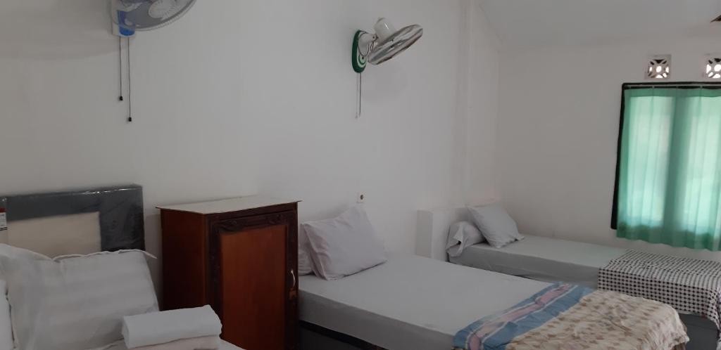 Postel nebo postele na pokoji v ubytování Diyah Homestay