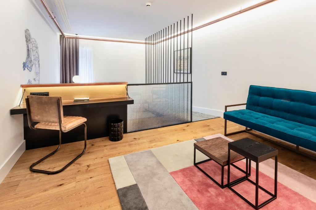 a living room with a couch and a table at One Shot Tabakalera House in Donostia-San Sebastián