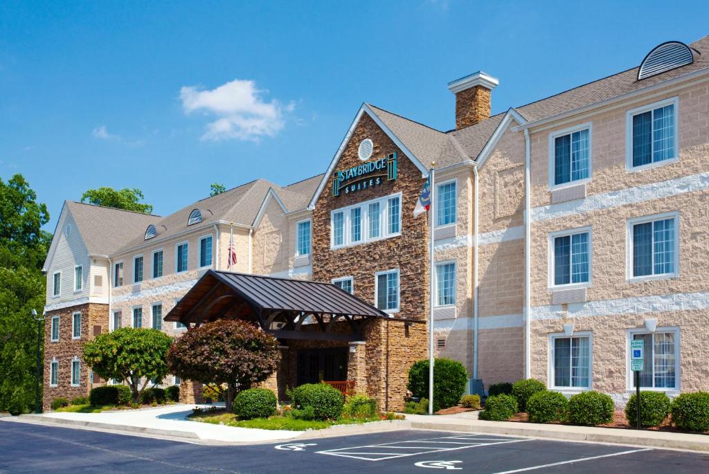 a large brick building with a parking lot at Staybridge Suites Raleigh-Durham Airport-Morrisville, an IHG Hotel in Morrisville