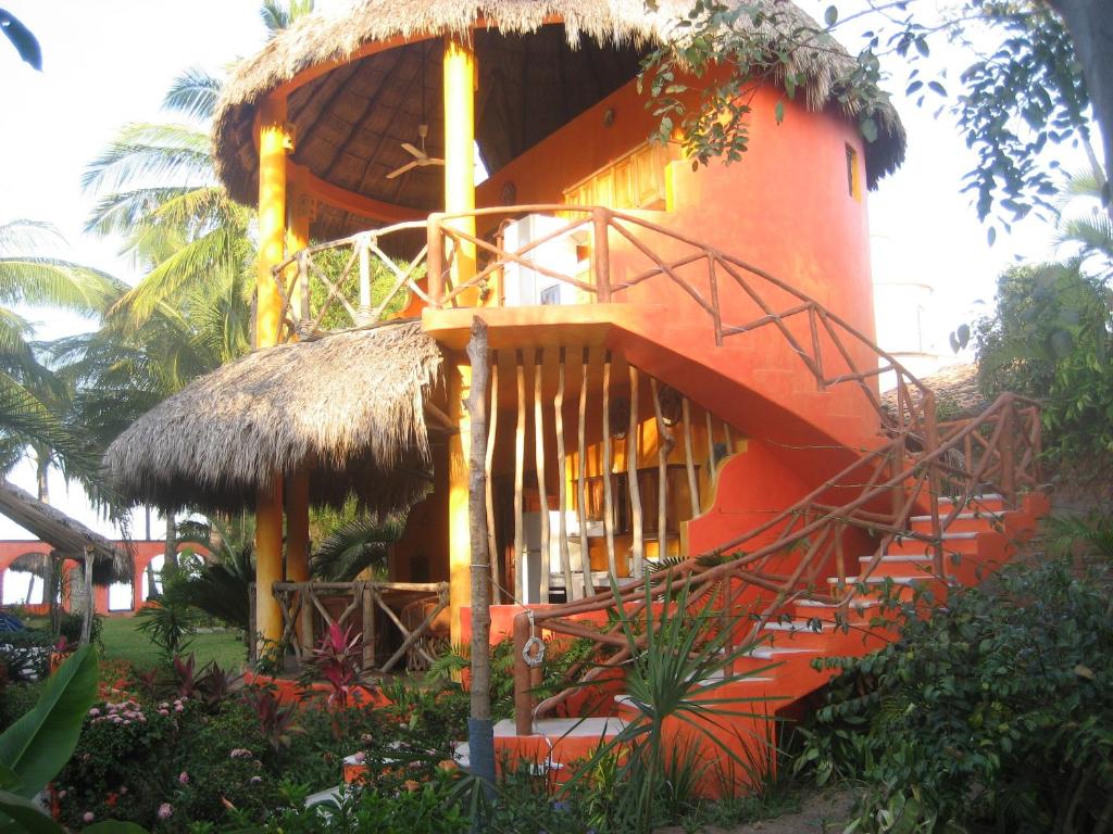 a building with a staircase in front of it at Unelma Bungalows in Bucerías