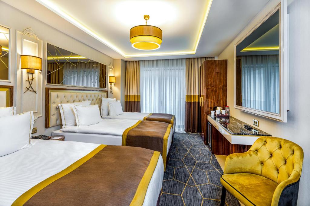 Postel nebo postele na pokoji v ubytování Beethoven Senfoni Hotel