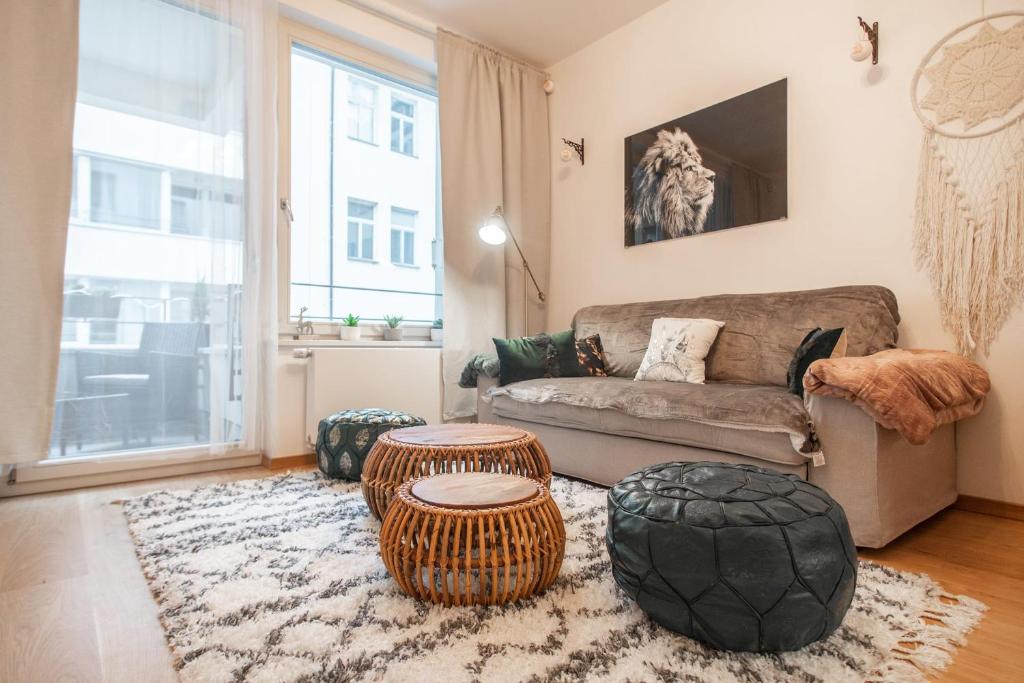 a living room with a couch and two tables at Apartment with Balcony in Prague