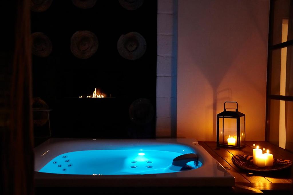 a bath tub in a room with a candle and a lantern at Musae Relais & SPA in Polignano a Mare