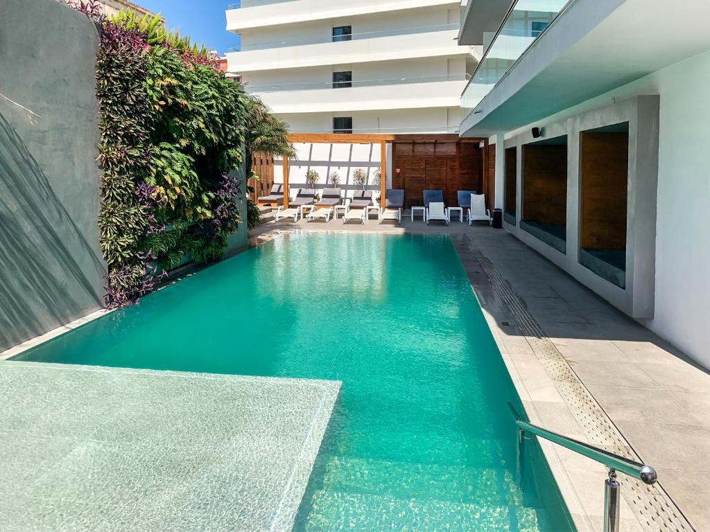 a swimming pool in the middle of a building at Manousos City Hotel in Rhodes Town