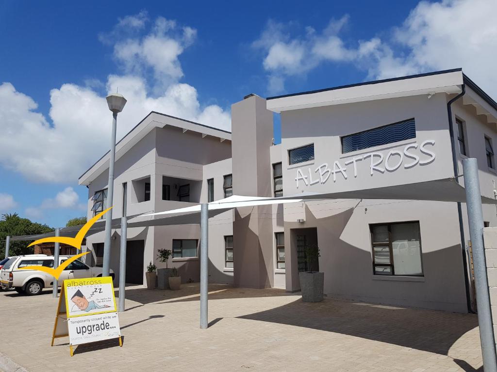 a north cross building with a sign in front of it at Albatross Guesthouse in Langebaan