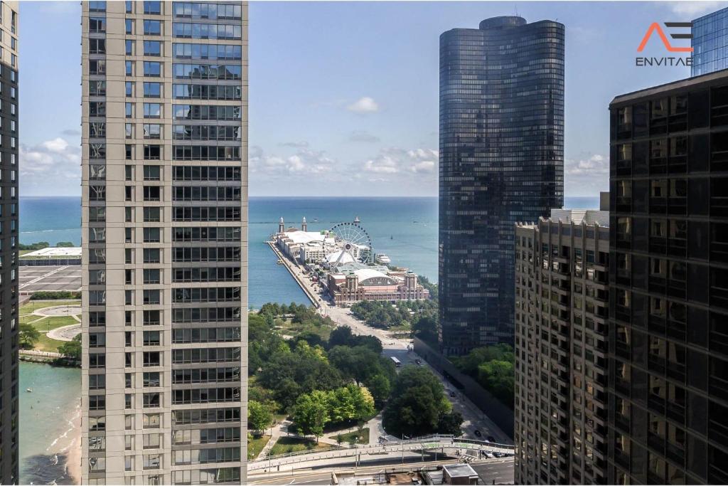 a view of the ocean between two tall buildings at Captivating Apartment with Pier Views, Pool and Gym in Chicago