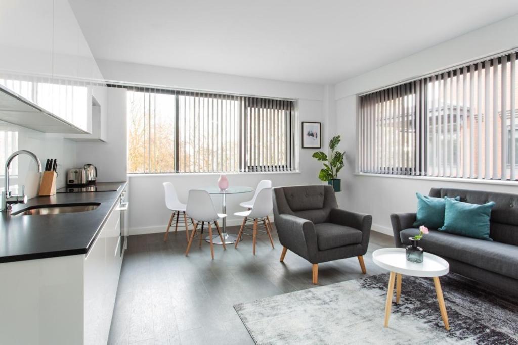 a living room with a couch and a table at Abbott House by Viridian Apartments in Saint Albans