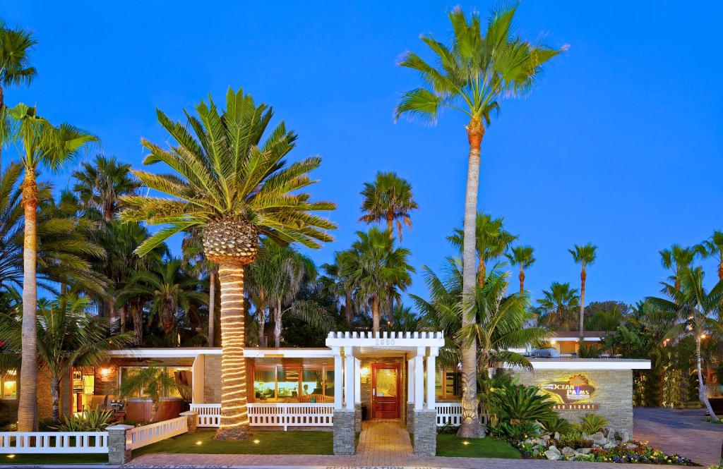 a palm tree in front of a house at Ocean Palms Beach Resort in Carlsbad