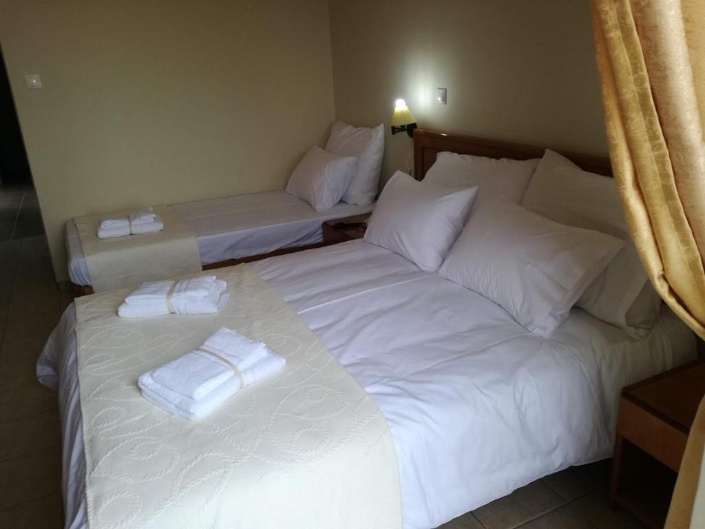 Postel nebo postele na pokoji v ubytování PARNON HOTEL