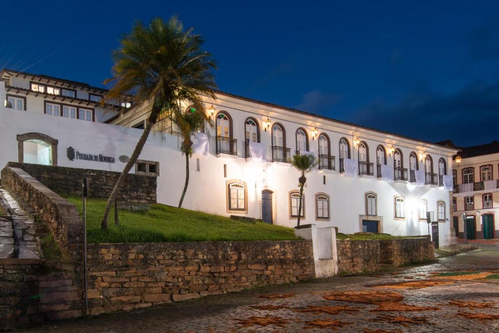 um edifício com uma palmeira em frente em Pousada do Mondego em Ouro Preto