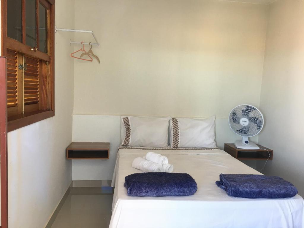 Suites Cerrado tesisinde bir odada yatak veya yataklar