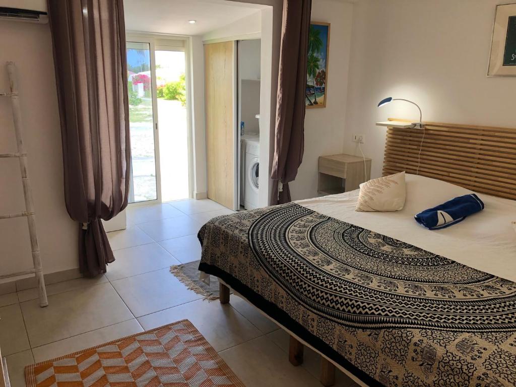 Postel nebo postele na pokoji v ubytování Duplex luxe au NBBC , les pieds dans le sable