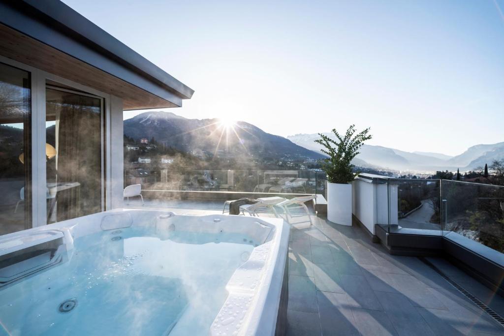 a hot tub on the balcony of a house at Be Place in Trento